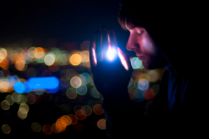Man praying over city at night