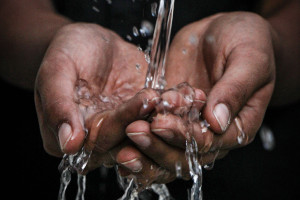 Fresh water pouring onto hands