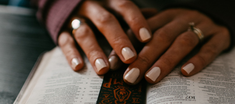 Woman's hands on her Bible as she reads