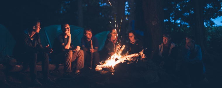 People praying round a campfire