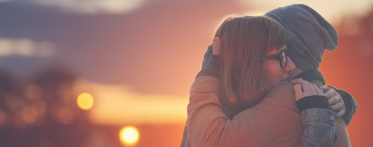 Two people hug tenderly