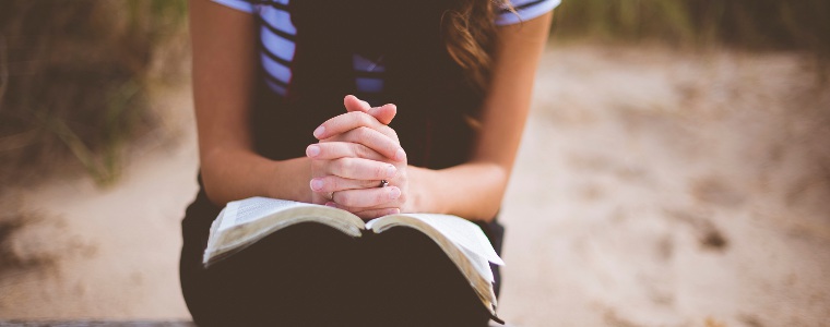 Woman on beach wanting to pray