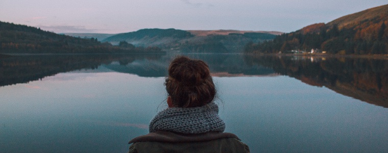 Woman gazing onto a lake