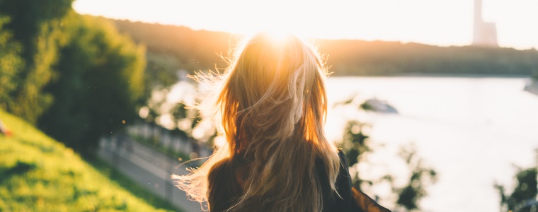 Woman really looking at a view into the sun