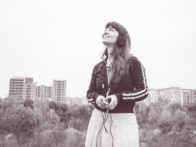 Woman with headphones looking upward